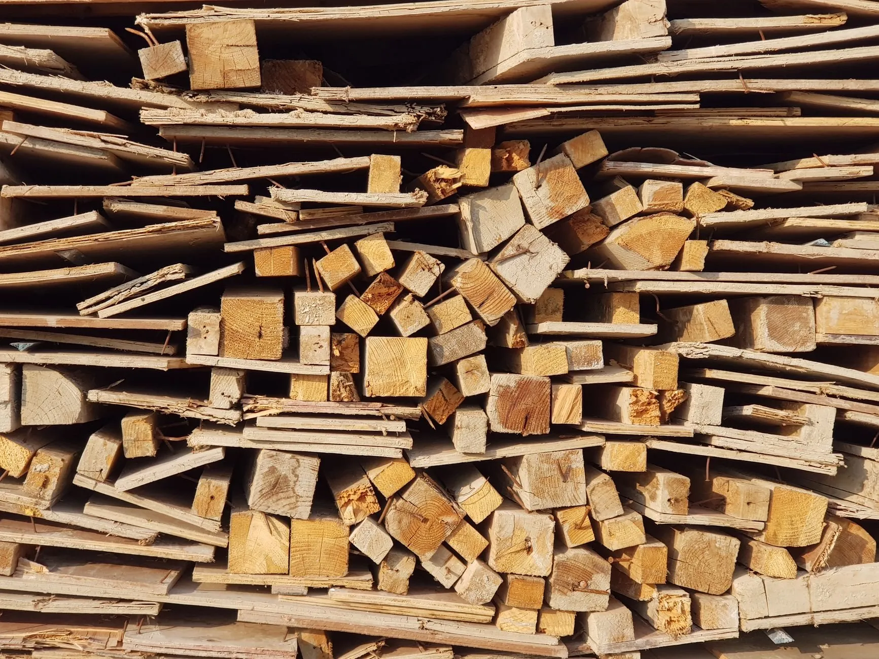 A stack of broken softwood battens and offcuts with nails still in them